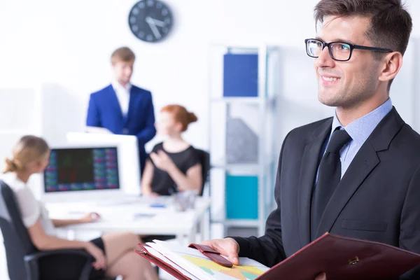 Elegant businessman and his employees — Stock Photo, Image