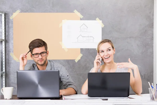 Co-workers sitting in front of computer screens — Stock Photo, Image