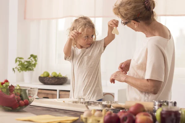 Kid showing cookies to nanny — Stock Photo, Image