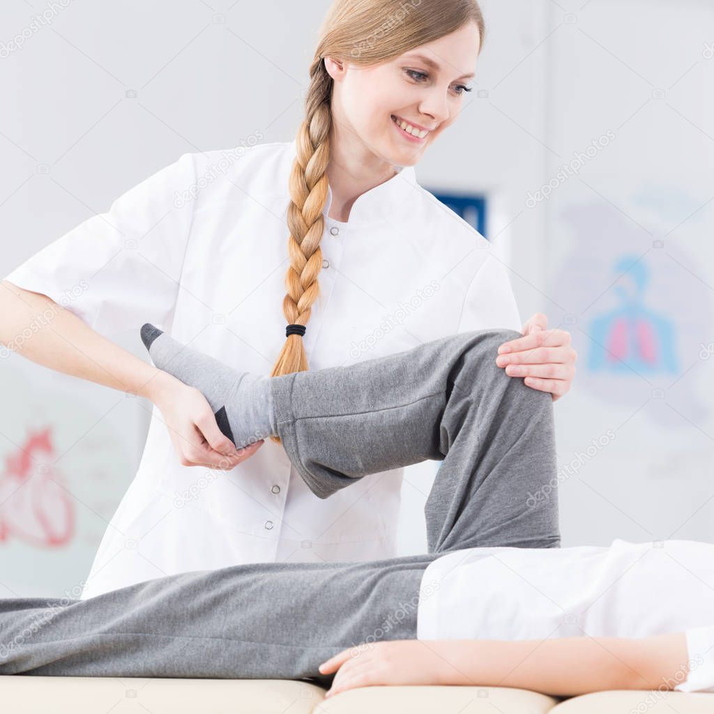 Physiotherapist rehabilitating patient