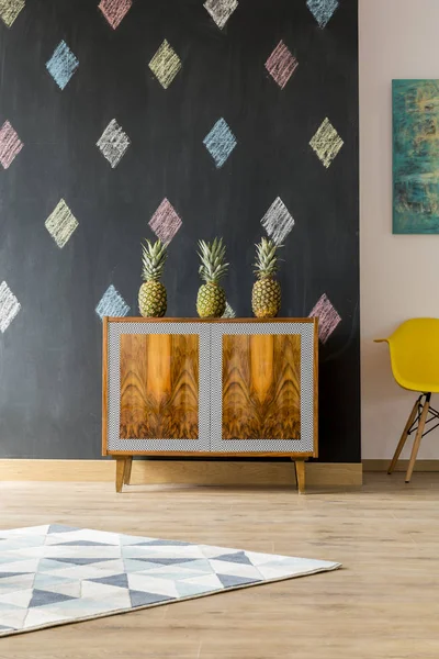 Shelf with pineapples on the black background — Stock Photo, Image