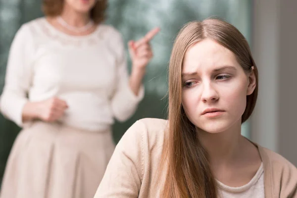 Sad girl and her mother reprimanding her — Stock Photo, Image