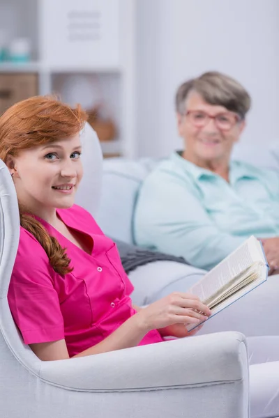 Caregiver with book — Stock Photo, Image