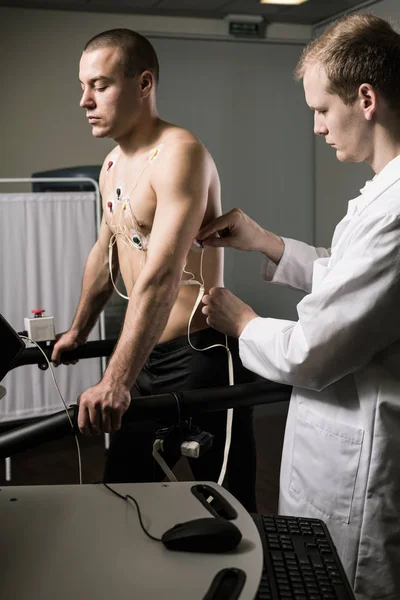 Athletic man with cardiogram electrodes — Stock Photo, Image