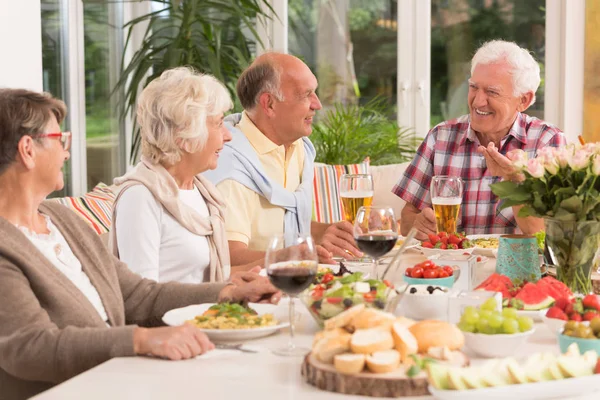 Група щасливих літніх людей, які їдять вечерю — стокове фото