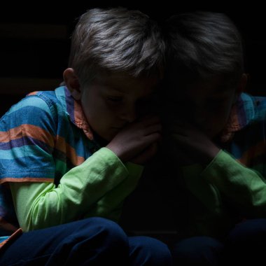 Frightened boy in the darkness clipart