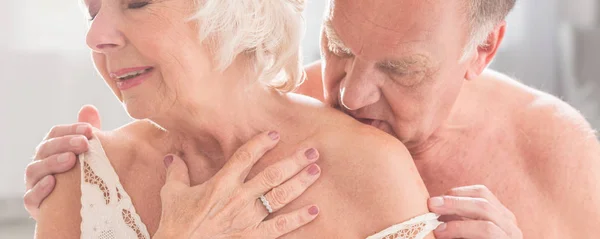 Hombre mayor besando esposa en lencería —  Fotos de Stock