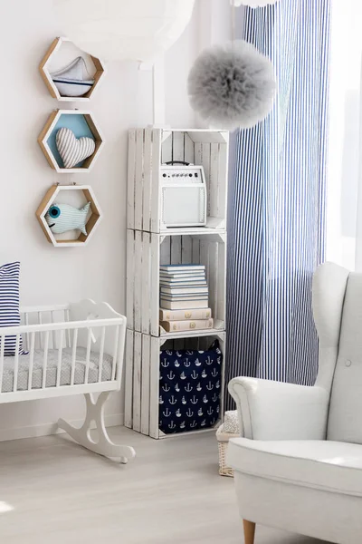 Neutral nursery with cradle and chair