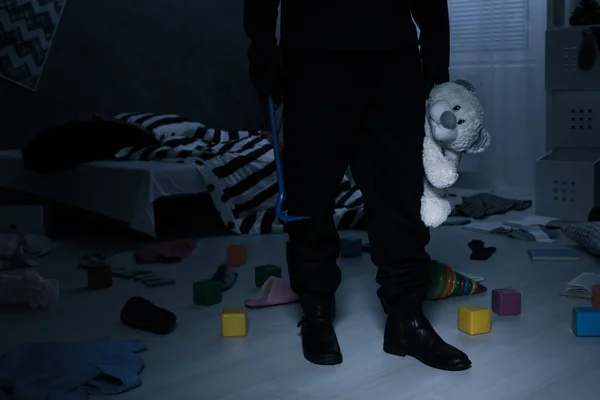 Burglar holding a teddy bear — Stock Photo, Image
