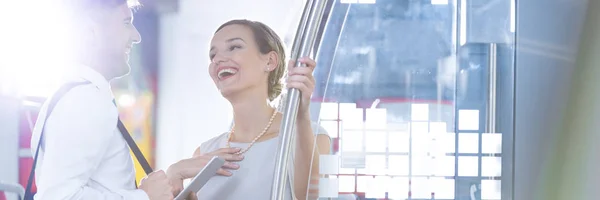 Laughing colleagues in train — Stock Photo, Image