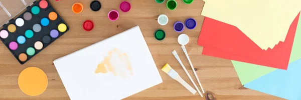 Paints, paint brushes and papers — Stock Photo, Image