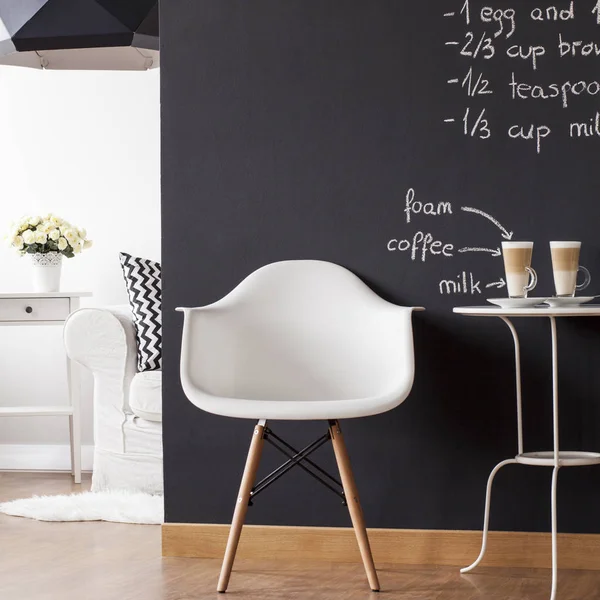 Minimalist flat with white armchair