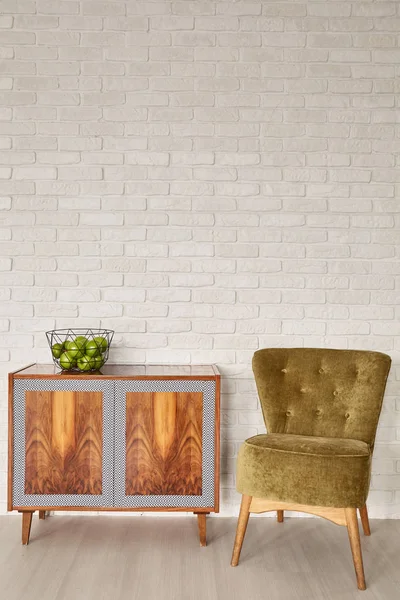 Brick wall, dresser and chair