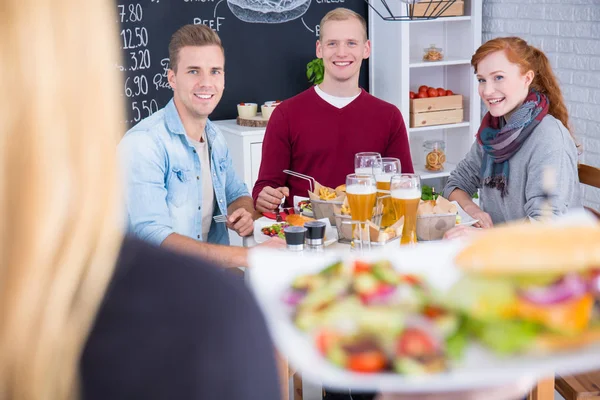 Woman holding plate with burger — Stock Photo, Image