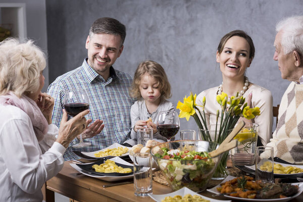 Grandmother proposing a toast with family