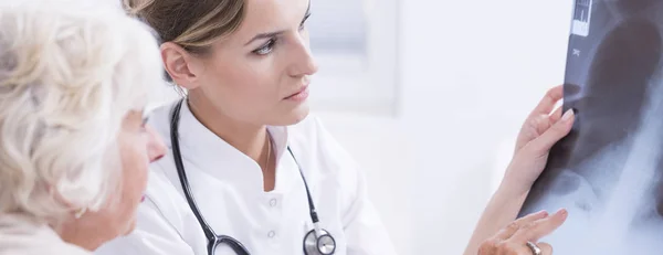 Médico mostrando al paciente una radiografía —  Fotos de Stock