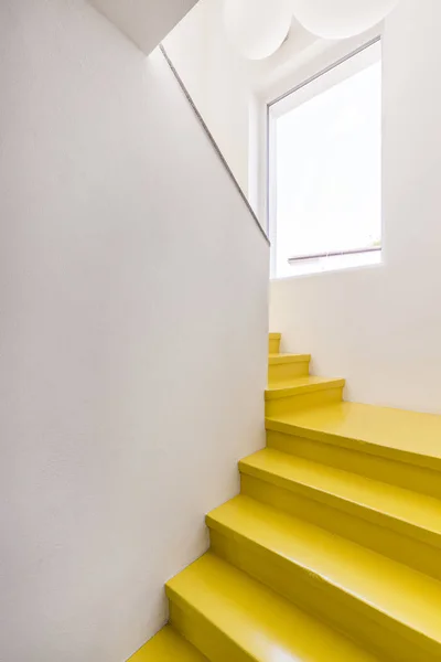 Yellow staircase in minimalist house