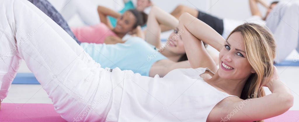 Happy woman doing crunches
