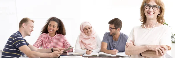 Smiling teacher and happy students — Stock Photo, Image