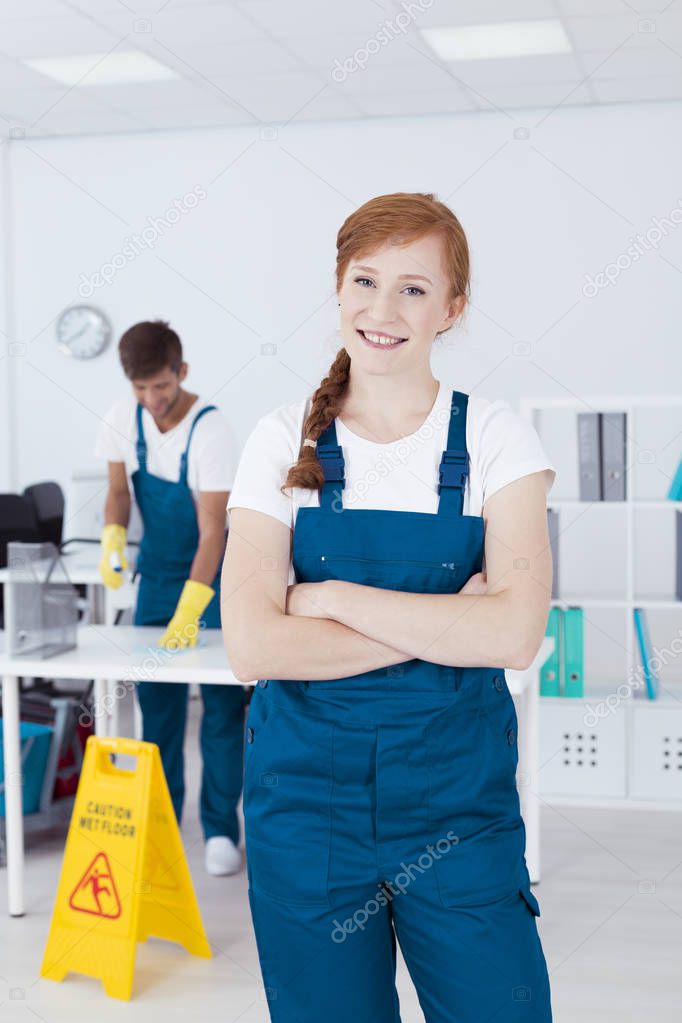 Smiling cleaner in office