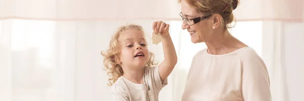 Grandma baking cookies with grandson