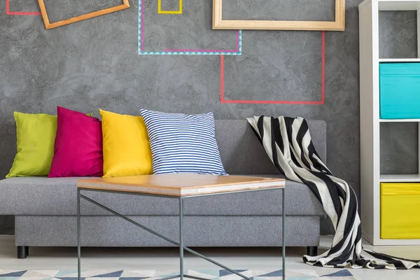 Grey sofa with colorful pillows — Stock Photo, Image