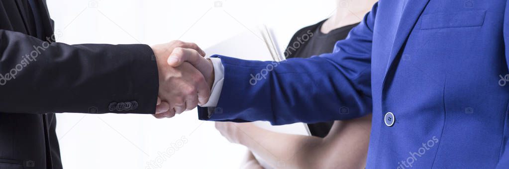 Managers in suits shaking hands