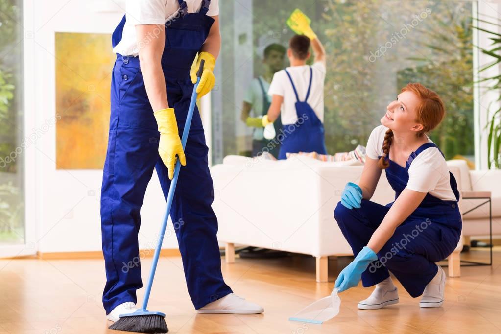 Cleaners sweeping floor