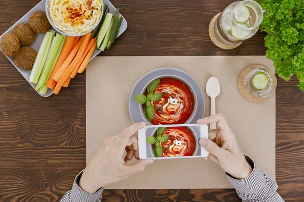 Man taking picture of soup — Stock Photo, Image
