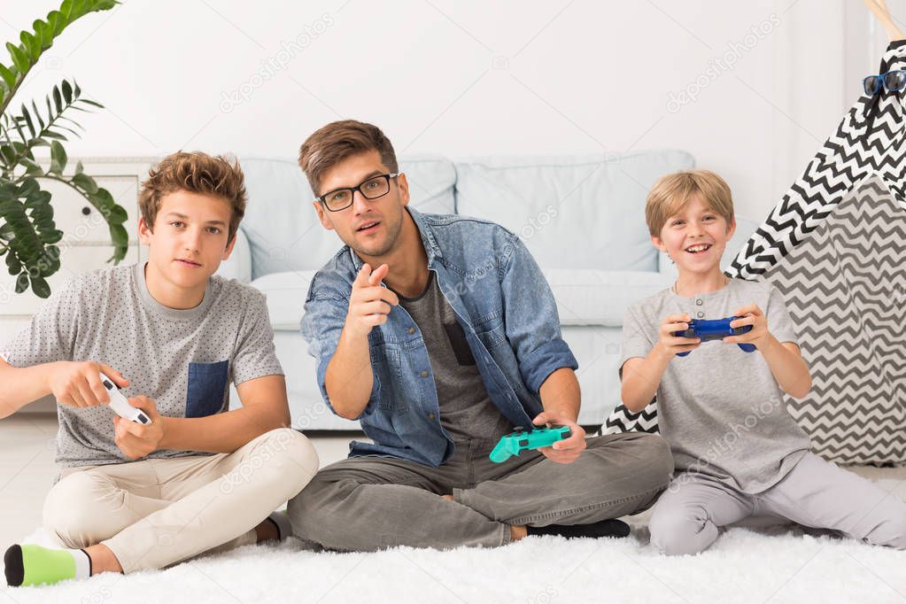 Dad playing video games with his sons
