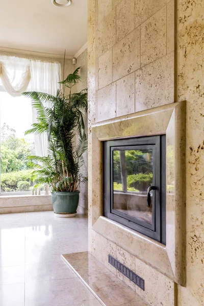 大きな窓の横にあるトラバーチン暖炉 — ストック写真