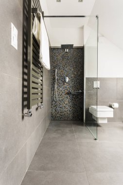 Grey bathroom with shiny tiles clipart