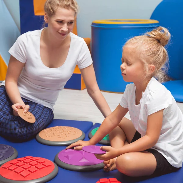 Child touching with closed eyes sensory integration equipment — Stock Photo, Image