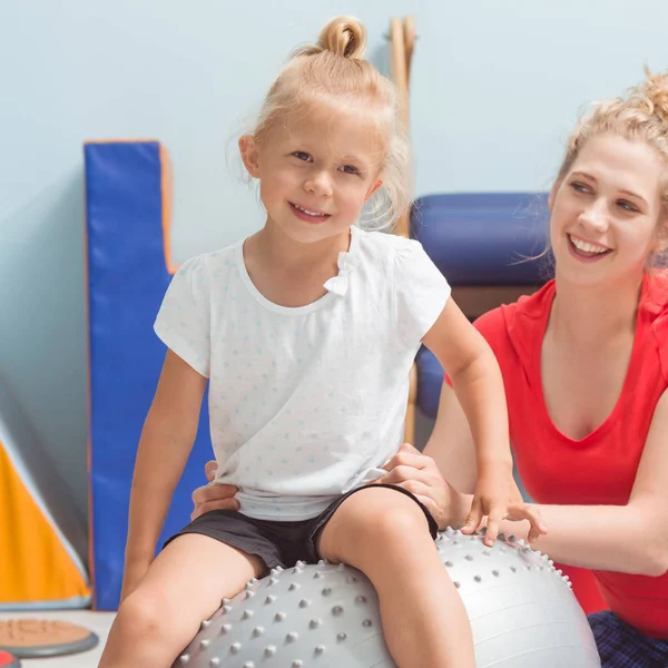 Child sitting on ball — Stock Photo, Image