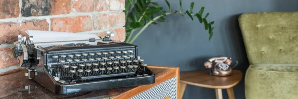Antique typewriter and armchair