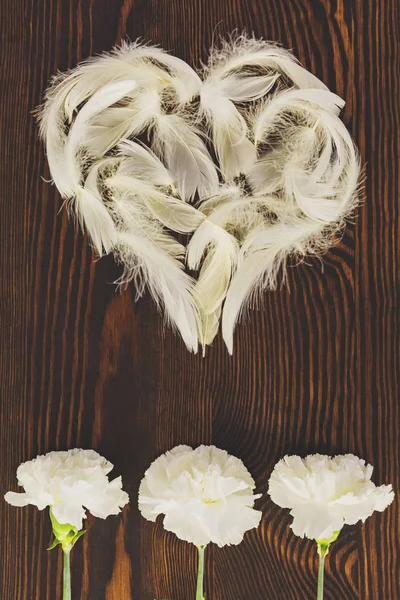 White feather heart and carnations