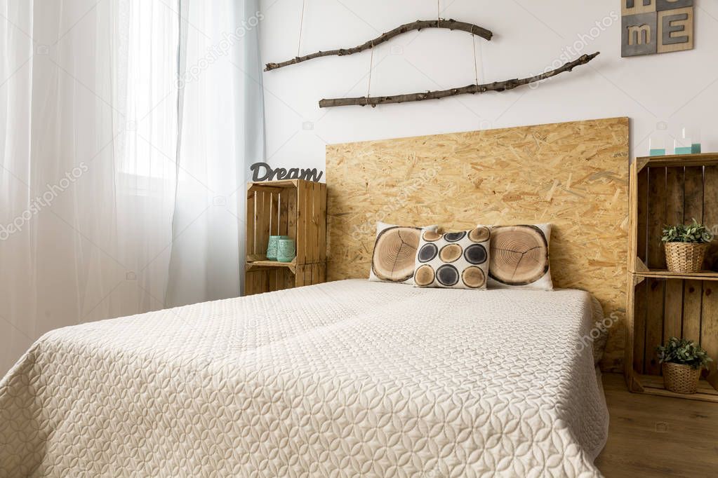 Beige bedroom with wooden decoration
