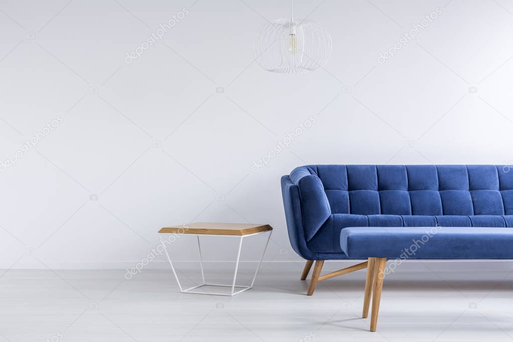 Room with blue sofa and bench