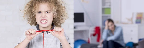 Boy breaking a pencil — Stock Photo, Image