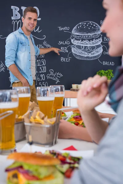 Man shows menu — Stock Photo, Image