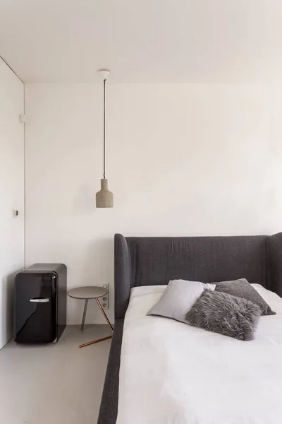 Schlafzimmer mit Bett und kompaktem Kühlschrank — Stockfoto