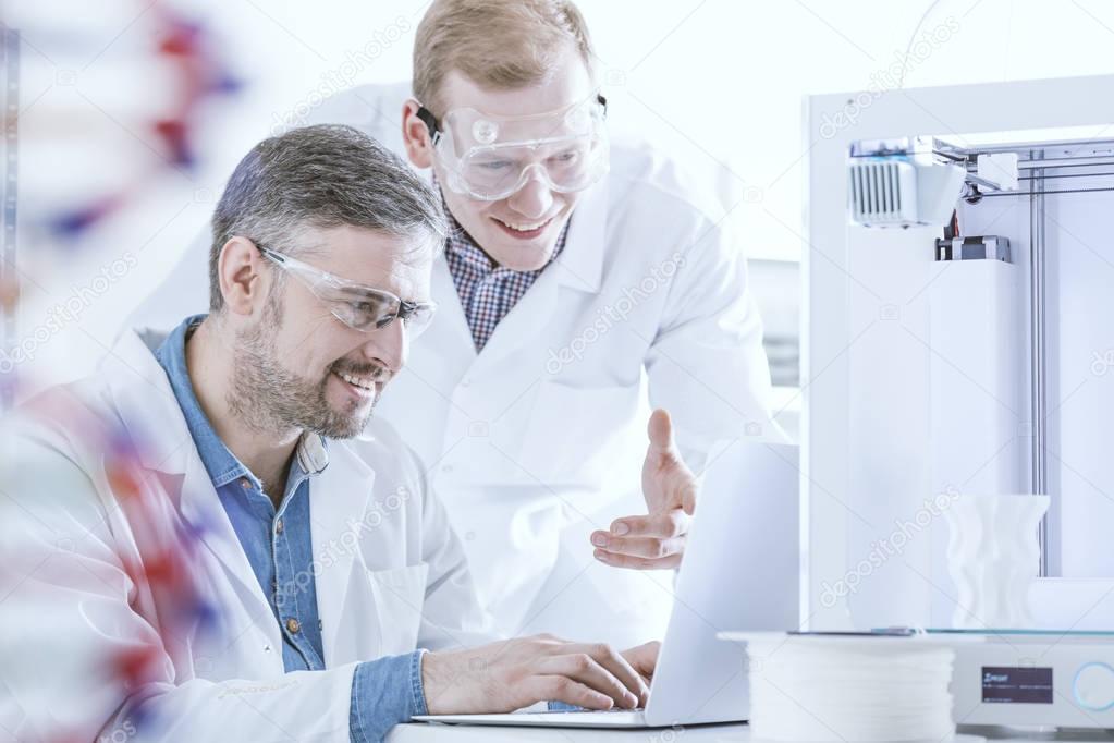 Chemists with laptop and printer