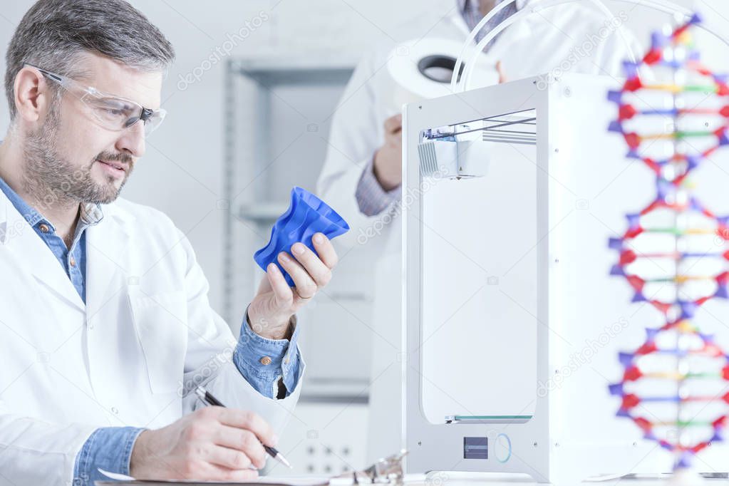Scientist holding 3d printed object