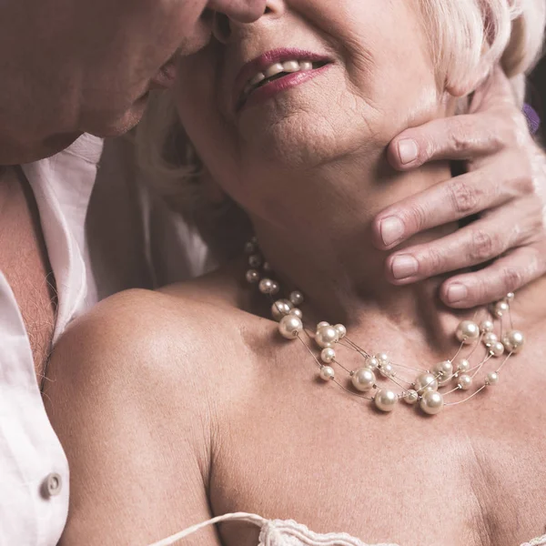 Senior couple kissing with desire — Stock Photo, Image