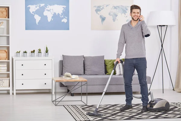 Happy man vacuuming — Stock Photo, Image