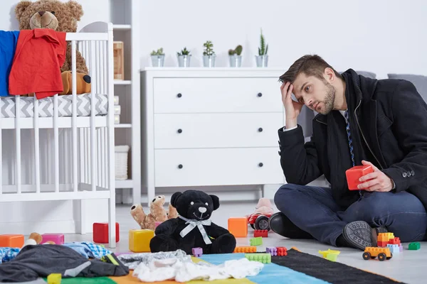 Tired father sitting on floor — Stock Photo, Image