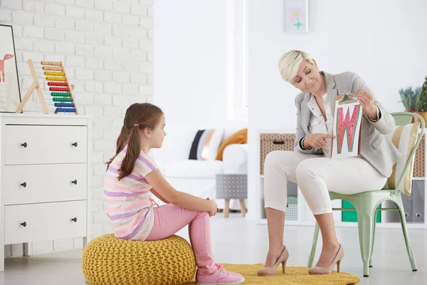 Girl learning reading difficult letters — Stock Photo, Image