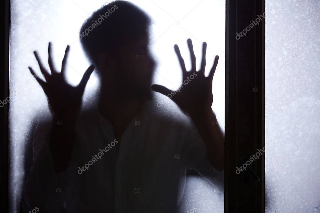 Man behind window