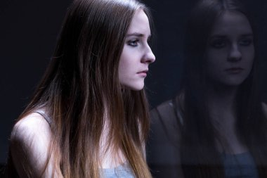 Reflection of sad, teenage girl clipart