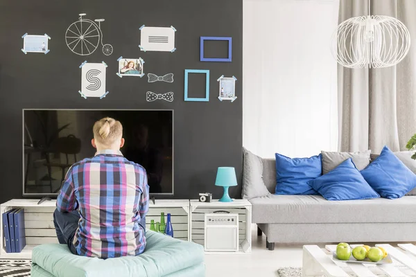 Young student in front of tv — Stock Photo, Image